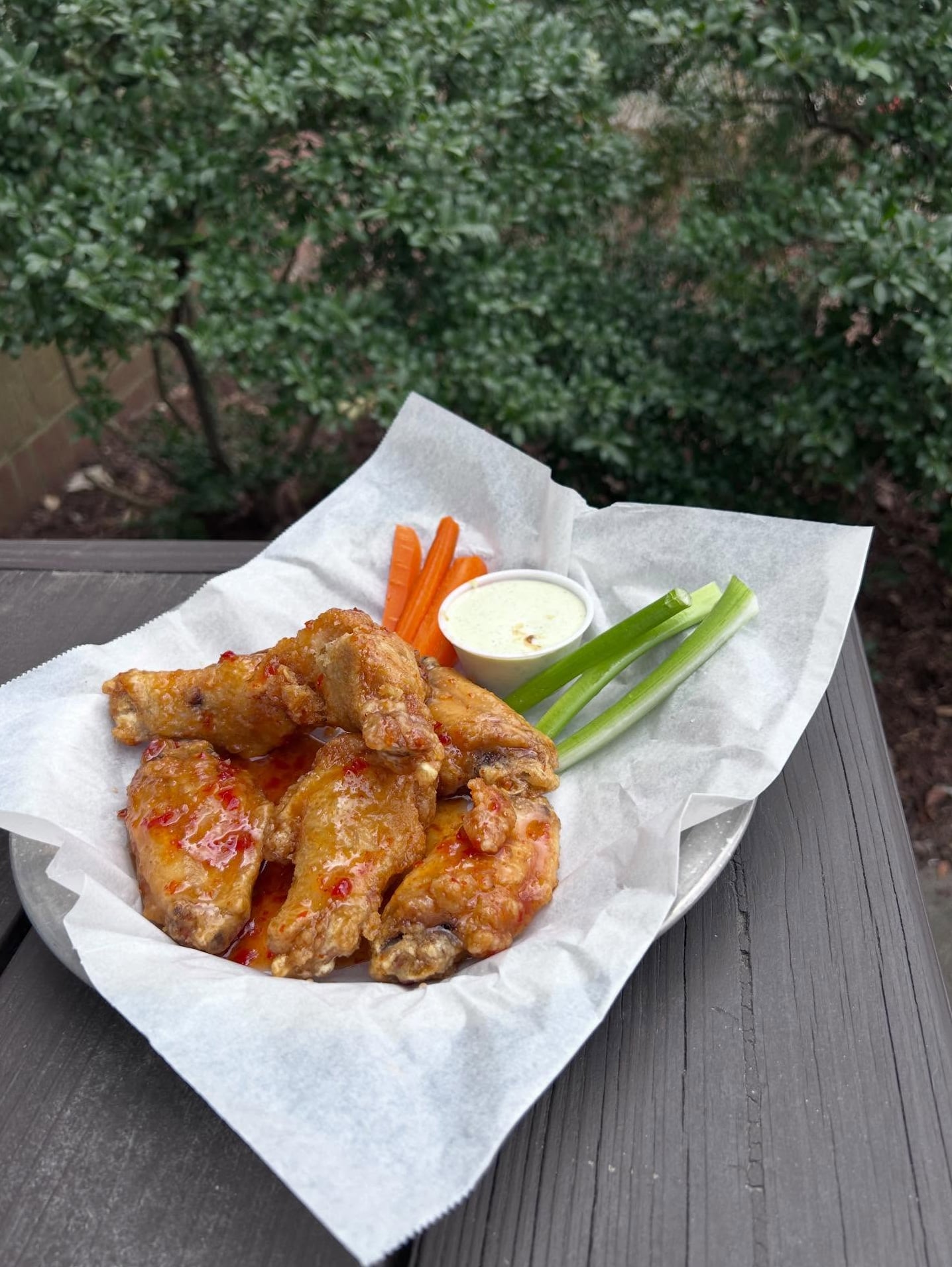 Wings with spicy sauce on the patio