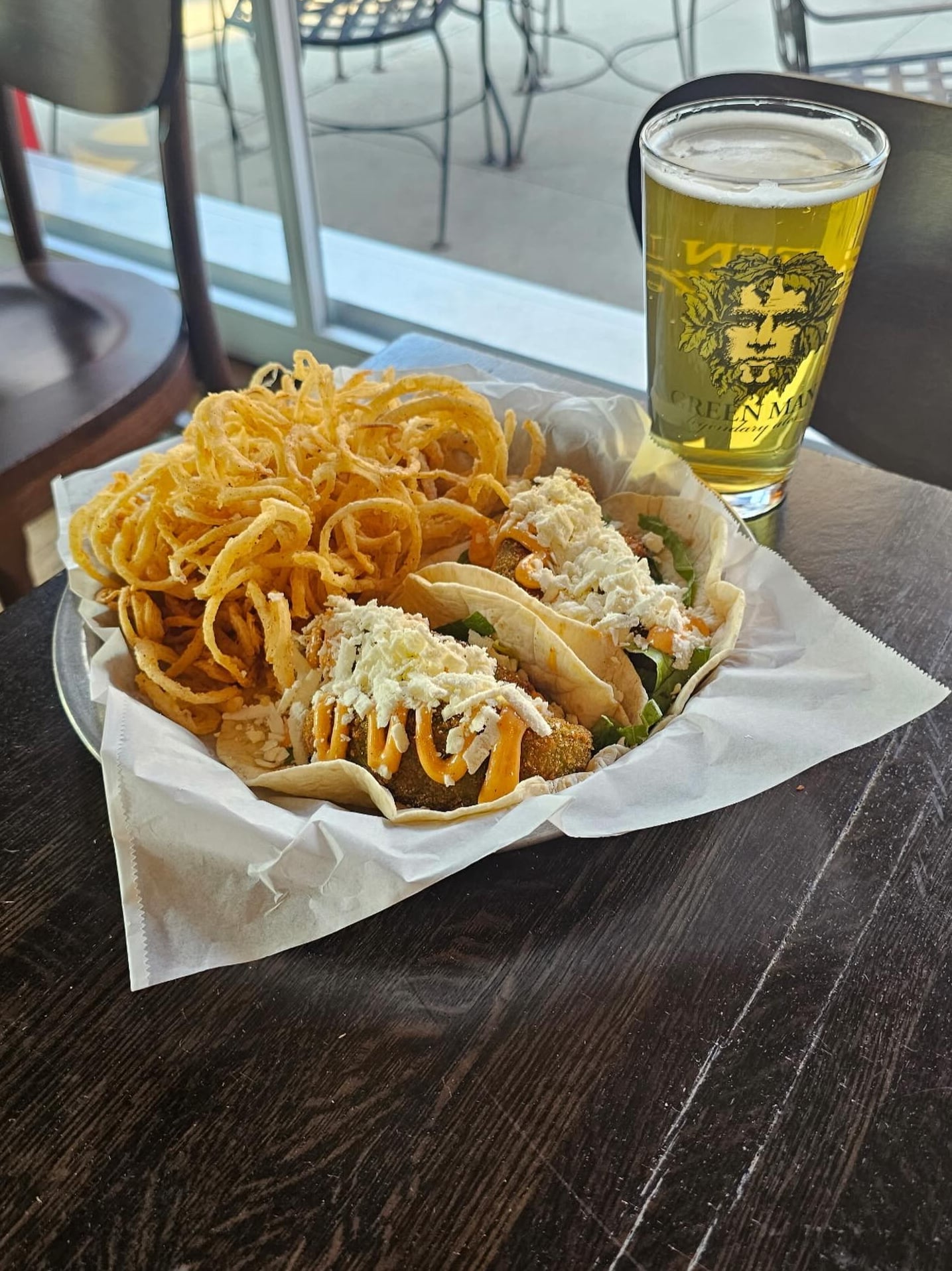 Signature tacos with curly onions and house beer
