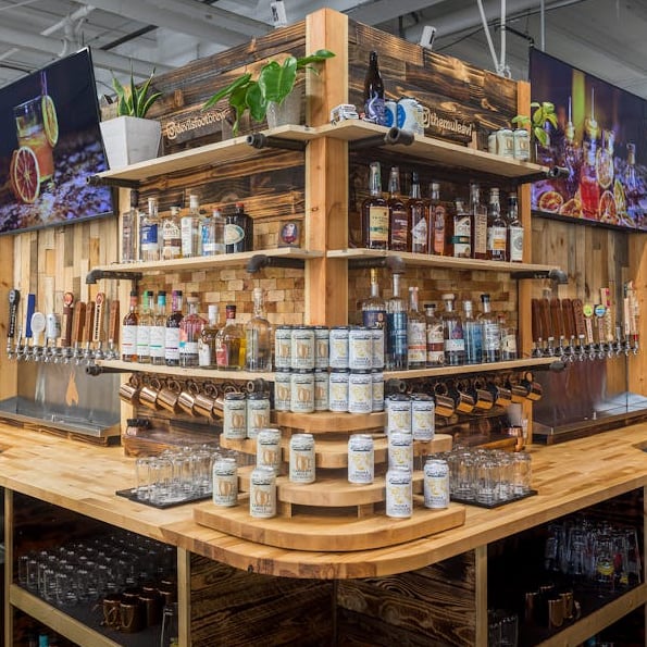 Rustic-style bar interior with extensive liquor display and draft taps
