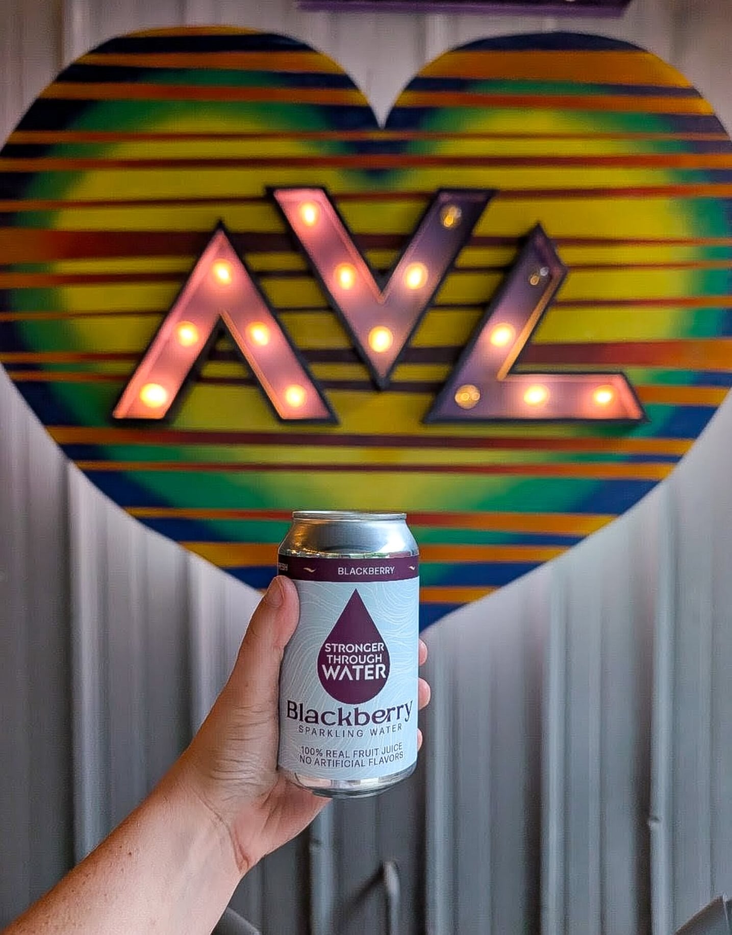 Retro vibes at AVL: Neon heart decor and refreshing drinks.