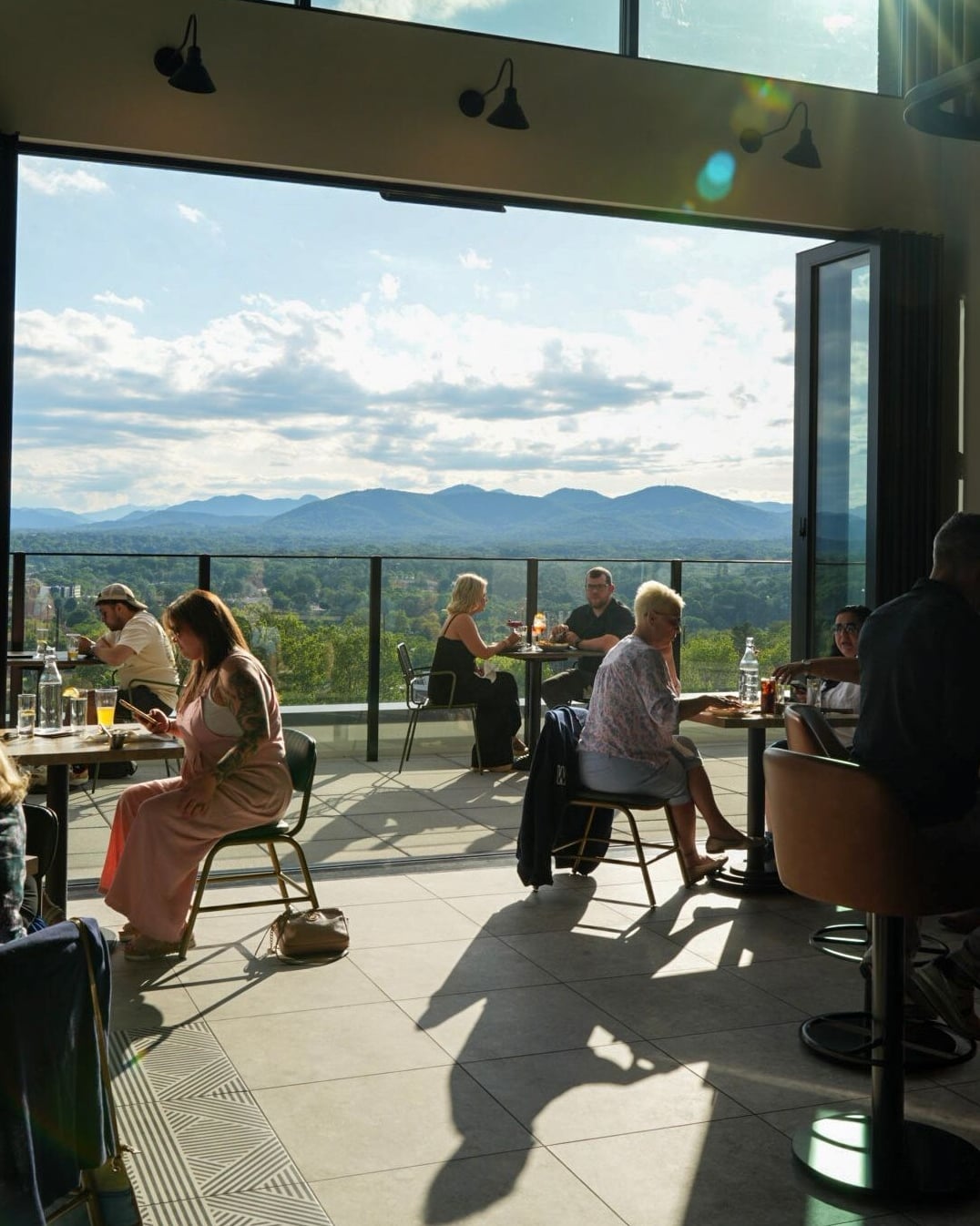 Scenic rooftop dining room with panoramic mountain views.