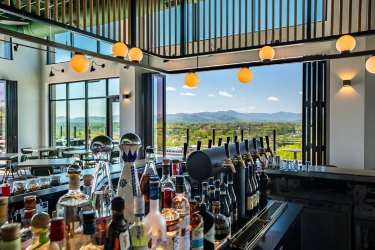 Modern bar featuring a full backbar overlooking scenic mountains.