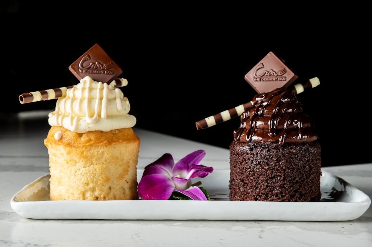 Artisanal mini cakes with signature 'Crave' branding.
