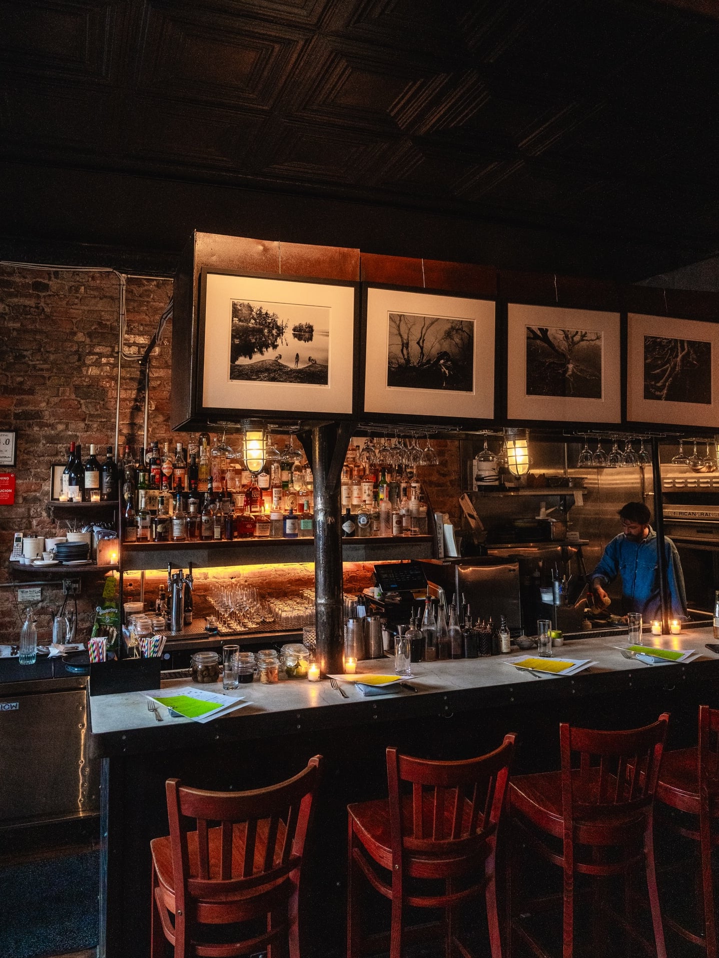 Classic dark wood bar with ambient lighting and exposed brick detailing