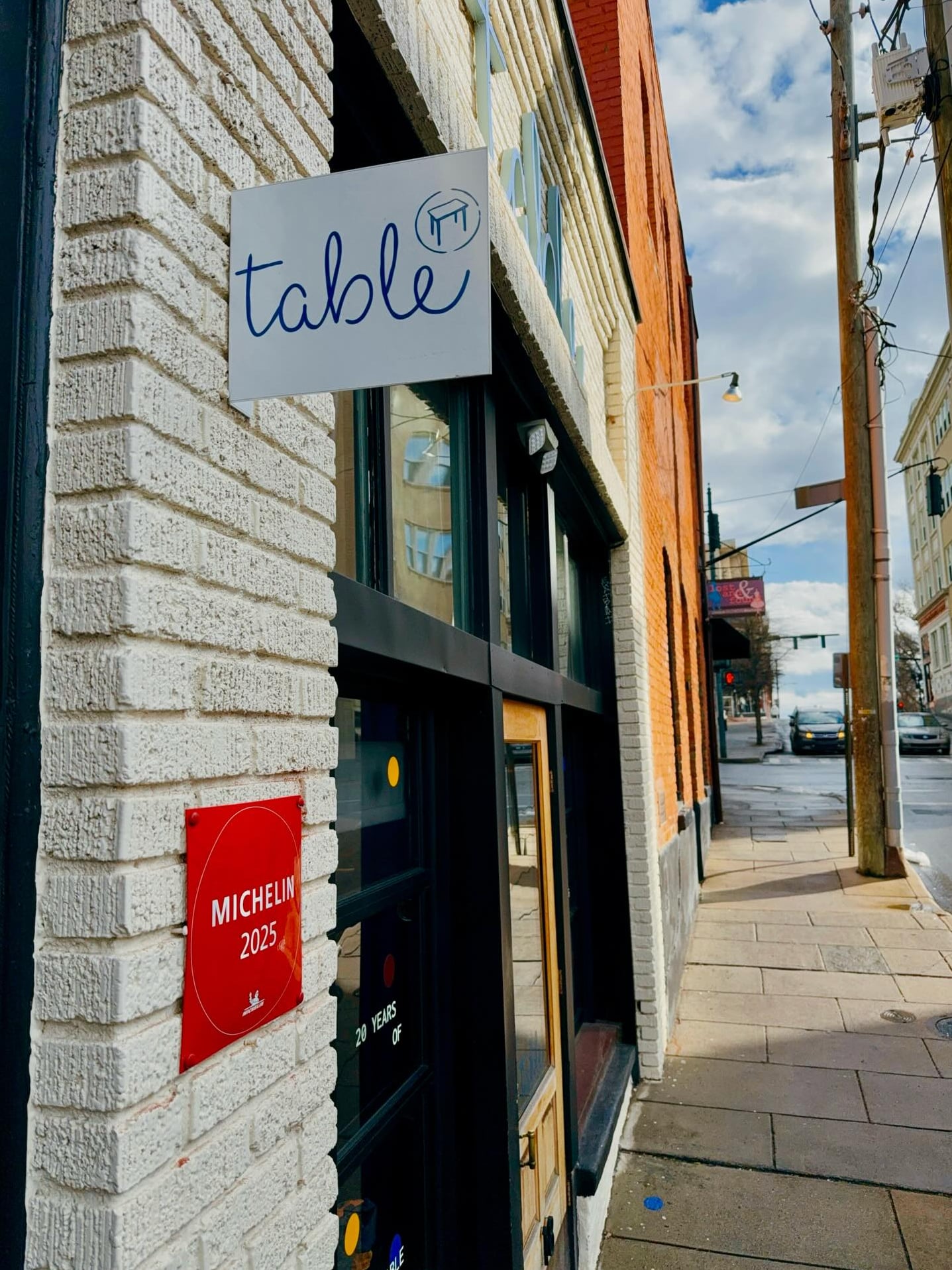 Table restaurant exterior featuring 2025 Michelin award plaque
