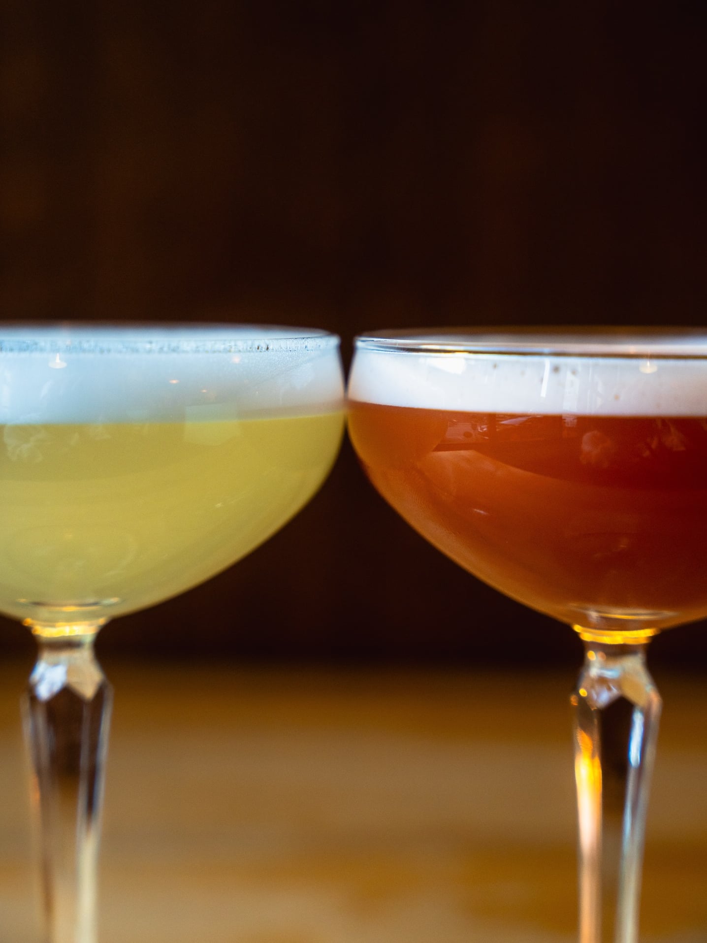 Two signature cocktails served in coupes