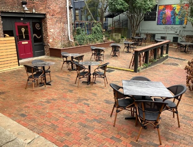 Hidden courtyard patio with outdoor seating and colorful mural