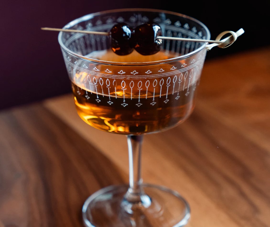 Classic amber old fashioned served in a vintage etched glass.
