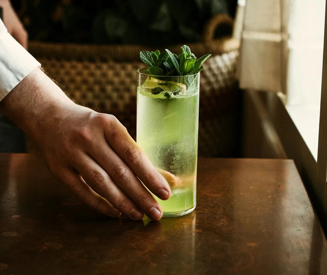 Freshly crafted mint mojito with natural lighting.