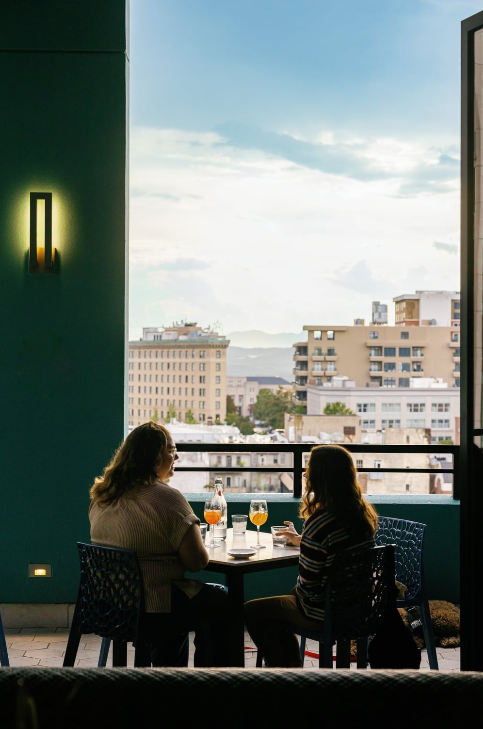 Intimate seating with panoramic city views at dusk