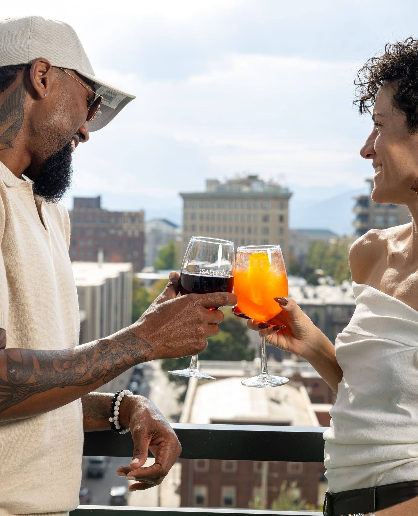 Guests toasting with cocktails against the Asheville skyline