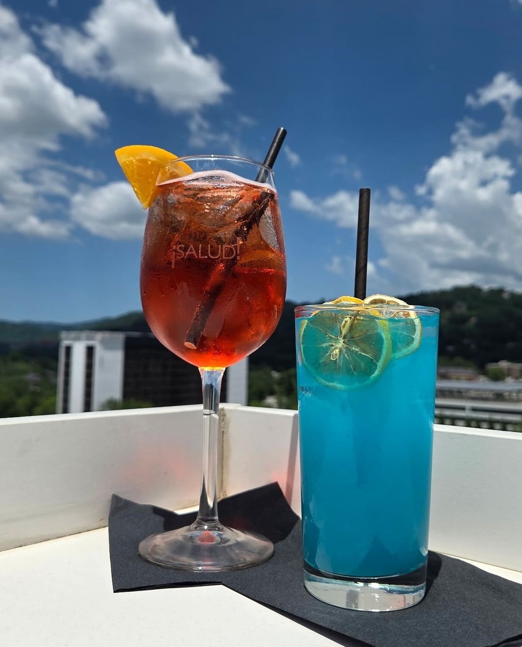 Signature cocktails with mountain and sky views from the rooftop