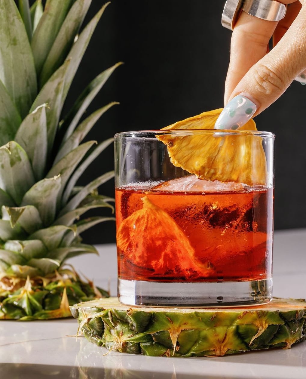 Tropical cocktail finished with a fresh pineapple garnish