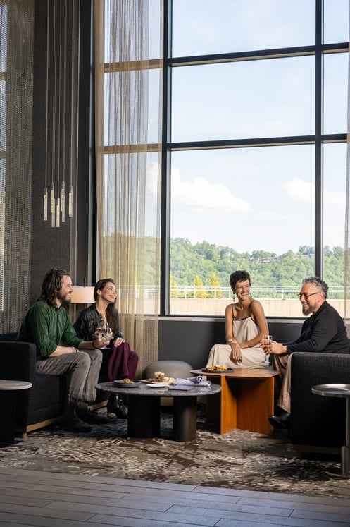 Lounge seating with floor-to-ceiling windows framing mountain views