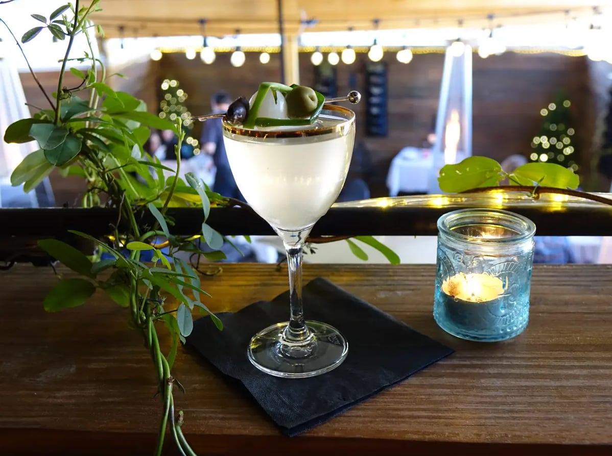 Pickled Ramp Martini with olive garnish, served on the patio