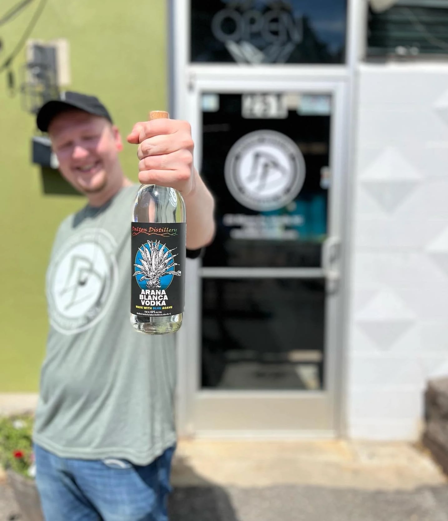 Dalton Distillery team member outside the storefront