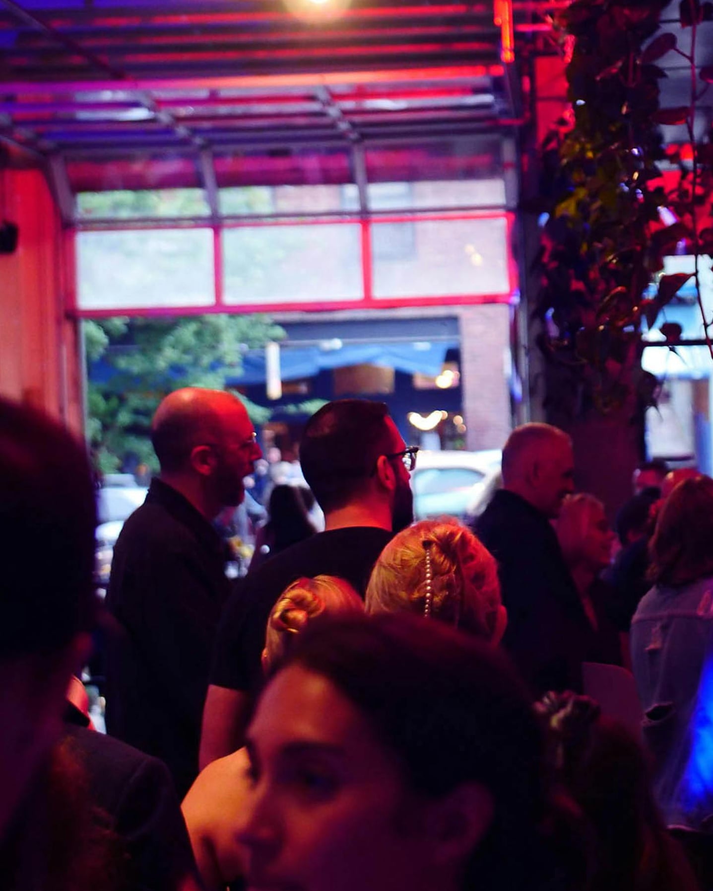Venue interior with red neon ambiance and bar seating