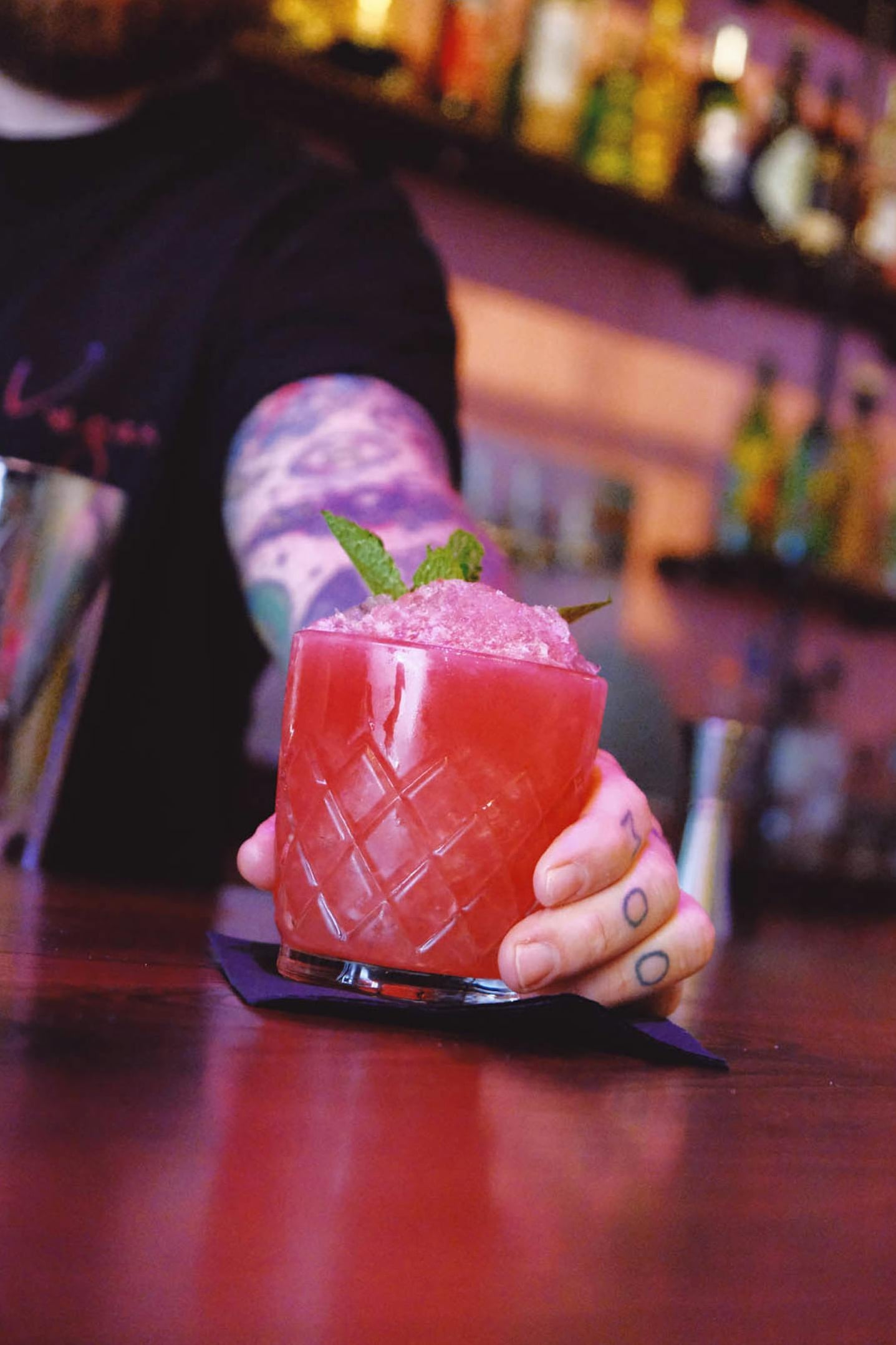 Signature red cocktail with mint and sugar rim