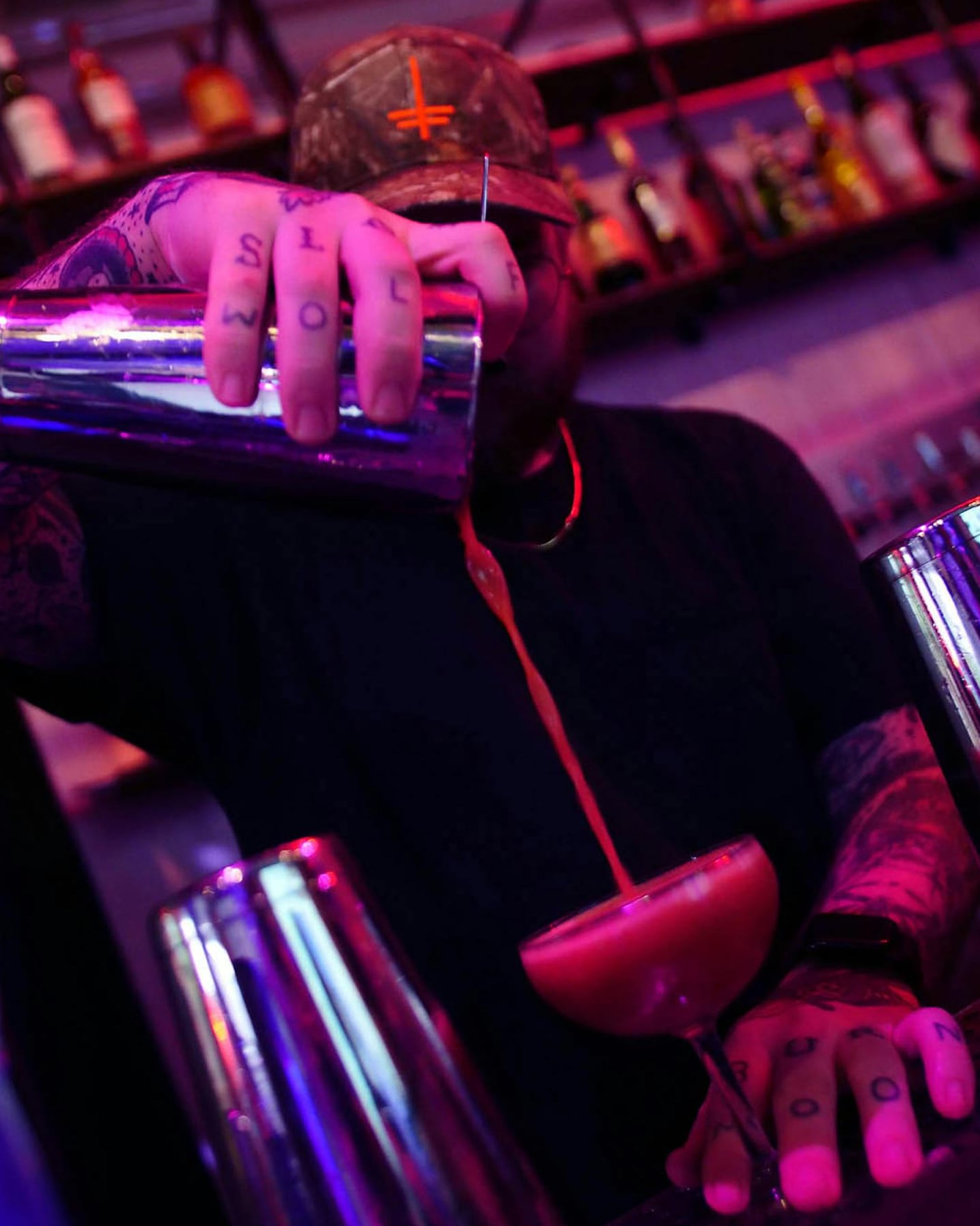 Neon-lit DJ equipment and bar area