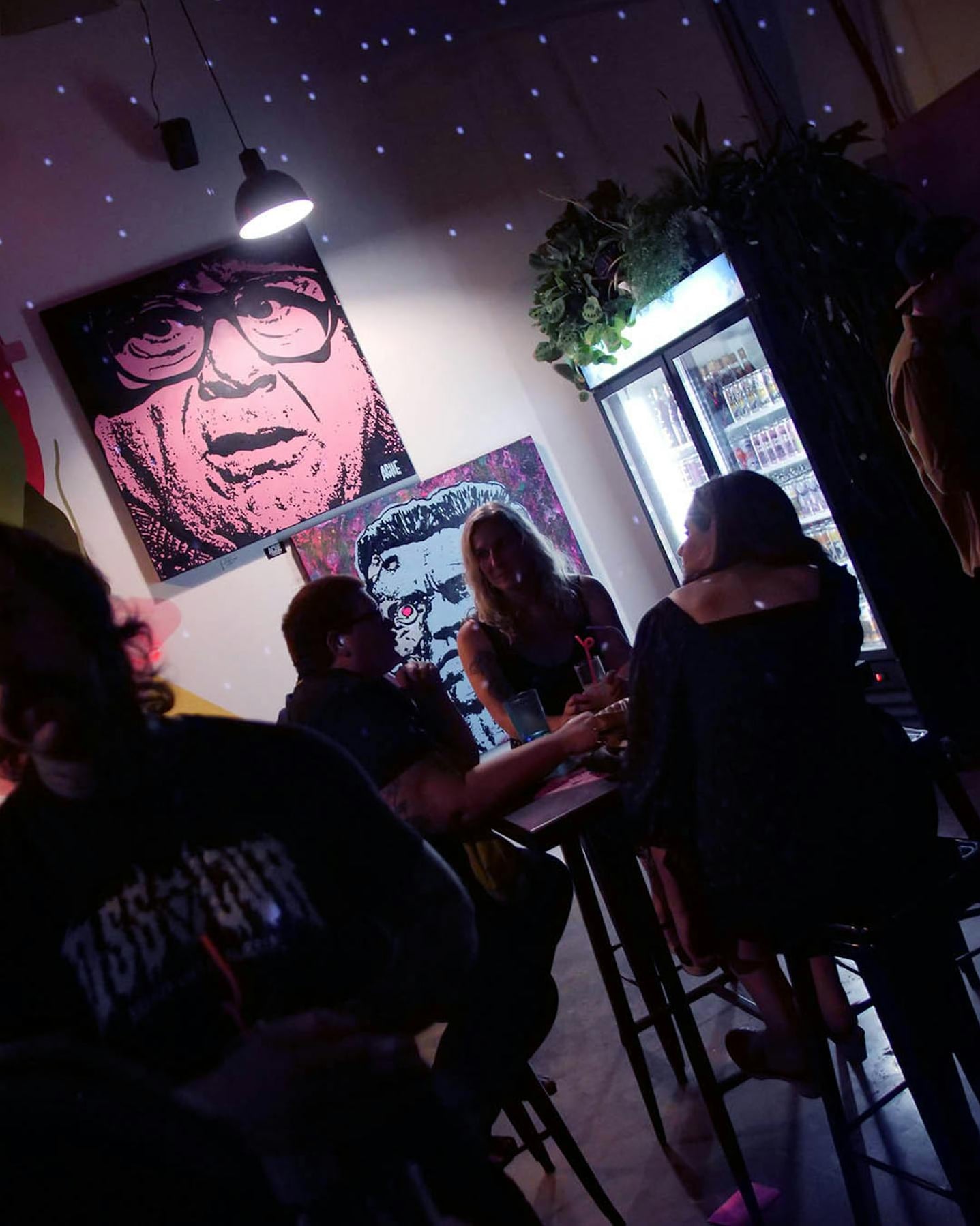 Dimly lit lounge area with pop art wall art