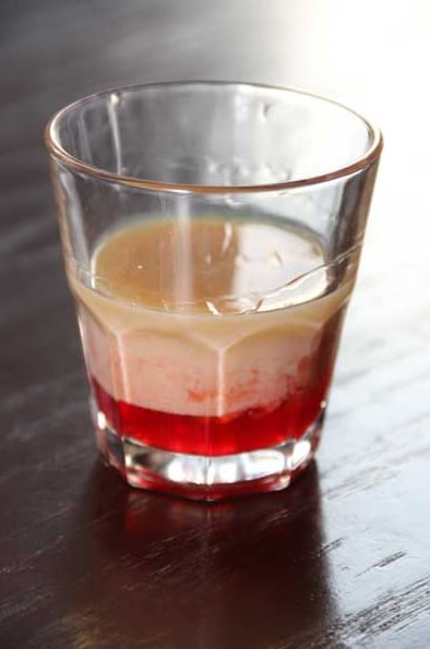Beautifully layered cocktail with red and clear layers
