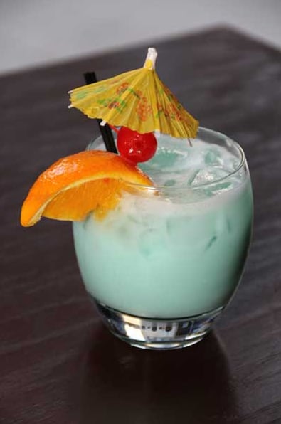Signature tropical cocktail with fresh mint and classic tiki garnish