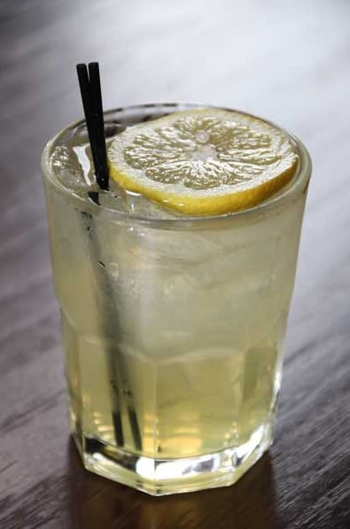 Amber-hued cocktail with fresh orange wheel