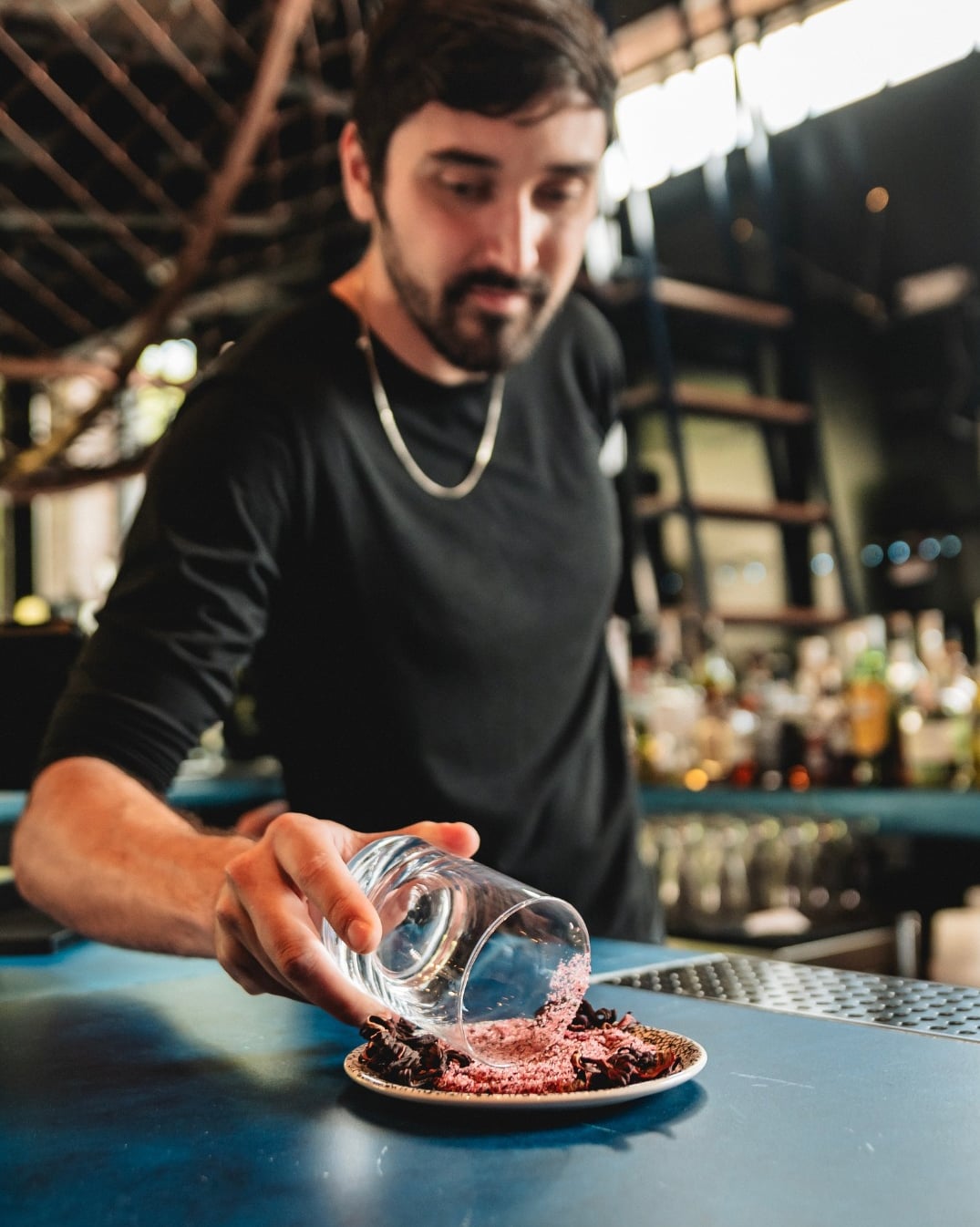 Bartender rimming a glass at the blue bar