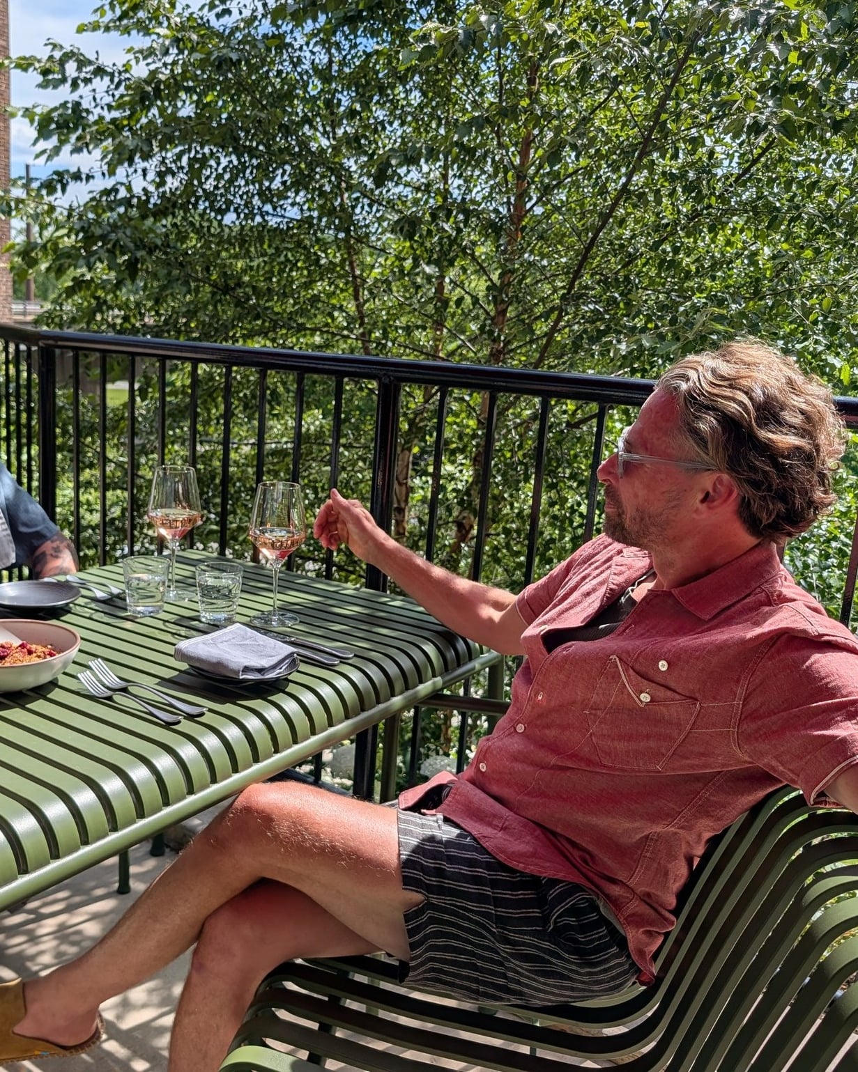 Sunny terrace seating with wine and brunch